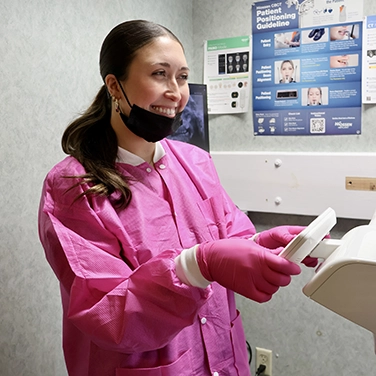 Santana using the X-ray at Singing River Dentistry.
