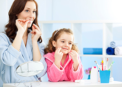 Mother and daughter taking care of their dental health