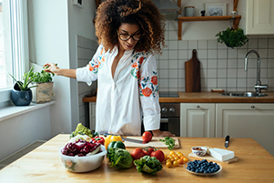 Black girl in her kitchen cooking healthy food