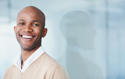 patient showing off his wonderful smile after restoring a discolored tooth