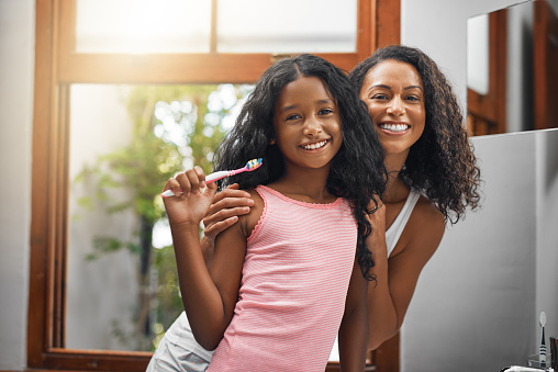 Beautiful Black woman and her daughter smiling