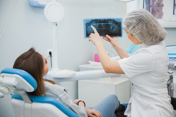 Dentist showing xray to patient at Singing River Dentistry in Florence, AL