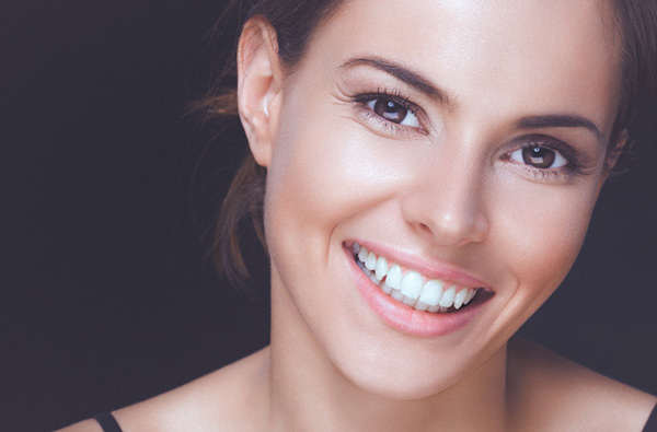 Woman smiling with perfect teeth after dental exam at Singing River Dentistry in Florence, AL